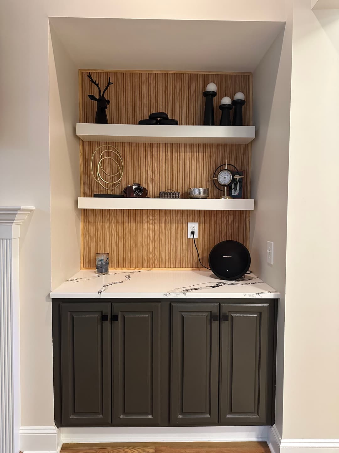 Modern home decor featuring a stylish cabinet with wooden shelves and decorative items.