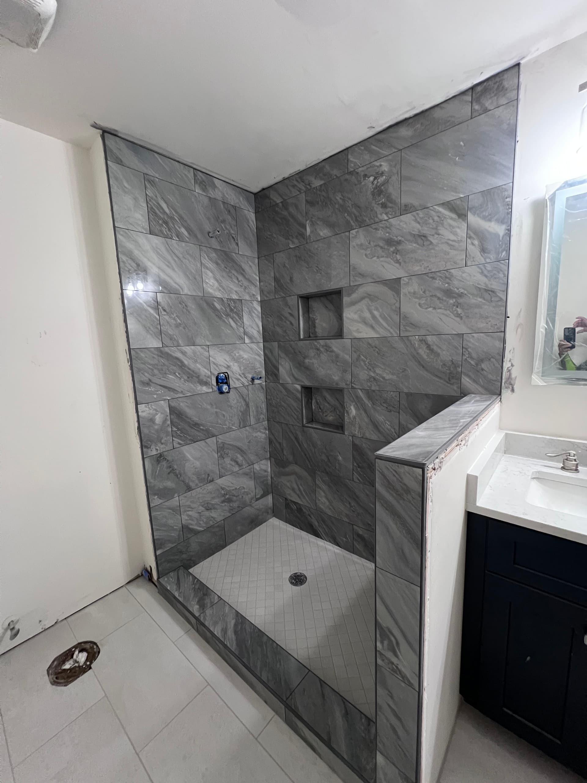 Fresh Bathroom Makeover Featuring Elegant Dark Gray Tiles image
